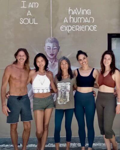 Tim Tango and yogis standing in front of soulful Mural at Villa Mantra Bali. Bali Vegan Book