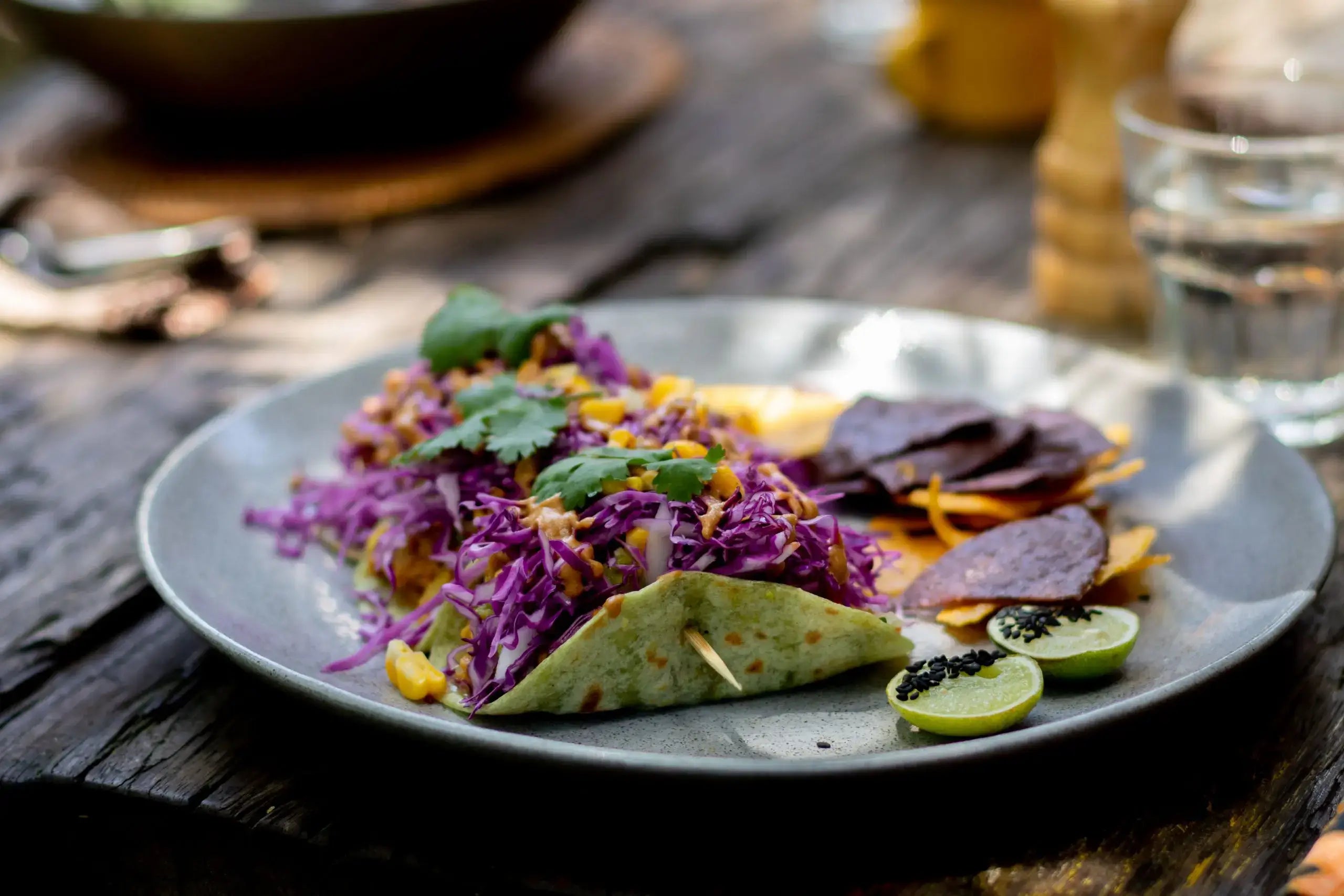 Vegan tacos on plate on wood table with recipe in Bali Vegan Book